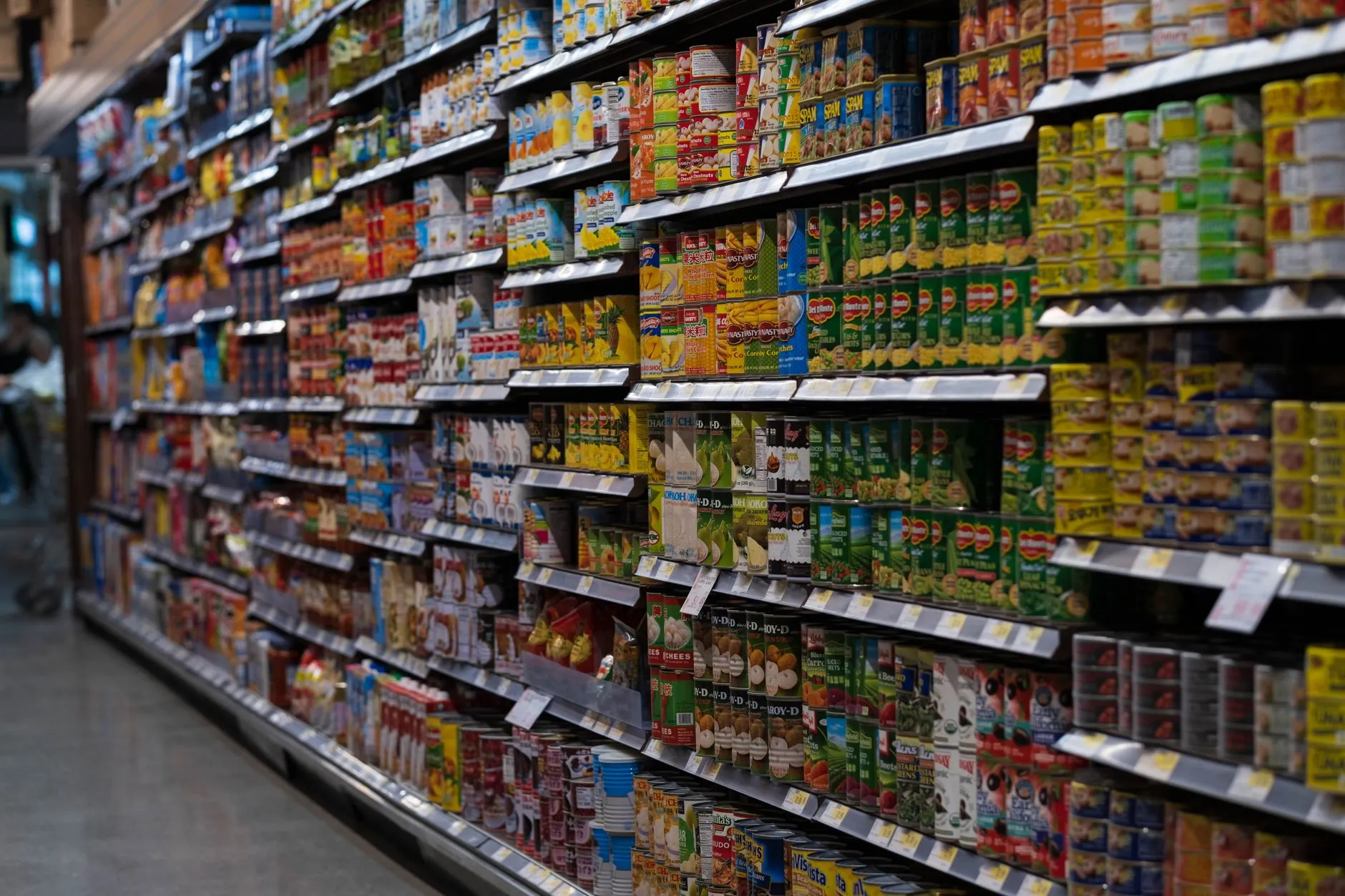 A long grocery store aisle stocked with packaged food